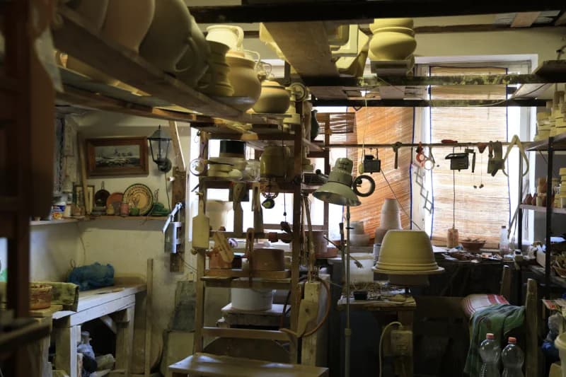 Pottery workshop interior filled with handmade ceramic vessels and tools
