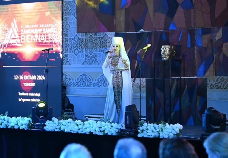 Performer in traditional attire singing on stage