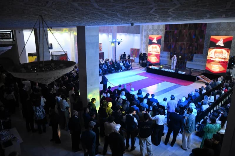 People gather inside a large hall for an event