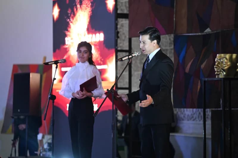 People speaking at an indoor event